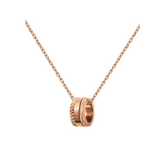 Rose gold Elevation Necklace featuring a sculpted geometric pendant with engraved detailing, hanging from a fine cable chain.