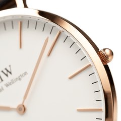Detail of the Classic Suffolk watch highlighting the polished rose gold case, eggshell white dial, and minimalist hour markers.
