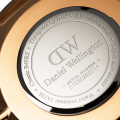 Engraved stainless steel case back of the Classic Cambridge Rose Gold watch, featuring Daniel Wellington branding and model details.
