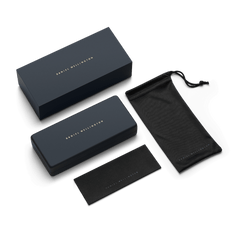 Premium Daniel Wellington sunglasses packaging including a navy blue presentation box, a hard protective case, a branded cleaning cloth, and a soft drawstring pouch.