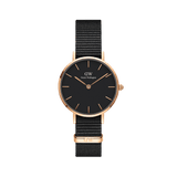 Daniel Wellington Petite Cornwall Rose Gold watch with black dial, rose gold case, and black woven NATO strap for women.