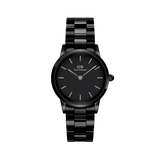 Sleek black ceramic watch with a polished link bracelet, minimalist black dial, and silver-tone hour markers and hands.