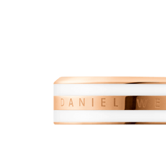 Close-up of the Emalie Ring in satin white and rose gold, featuring a polished enamel band with the Daniel Wellington logo engraved.