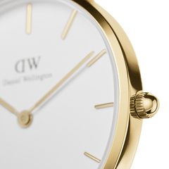 Close-up of Petite Sheffield Gold women’s watch showing gold case, minimalist white dial, and slender gold hands.