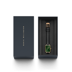 Quadro Pressed Sheffield Emerald Rose Gold watch with a green rectangular dial, rose gold case, and black leather strap presented in a sleek Daniel Wellington gift box.