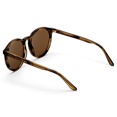 Bio-Acetate Arch Brown Demi sunglasses with round amber lenses, a lightweight tortoiseshell-effect frame, and Daniel Wellington branding on the arms.