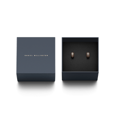 Emalie Earrings Rose Gold Black presented in a navy Daniel Wellington gift box, showcasing the elegant rose gold hoops with black enamel detailing.