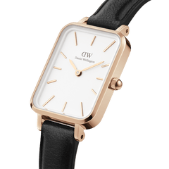 Daniel Wellington Quadro Pressed Sheffield watch with a rectangular eggshell white dial, rose gold-plated stainless steel case, minimalist rose gold markers, and a black leather strap.