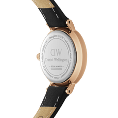 Close-up of the Petite Pressed Sheffield Black Rose Gold watch showing the engraved stainless steel case back, rose gold detailing, and black leather strap.