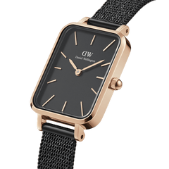 Close-up of the Quadro Pressed Ashfield watch featuring a rectangular black dial, rose gold case, minimalist hour markers, and a black pressed mesh stainless steel strap.
