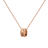 Rose gold Elevation Necklace featuring a sculpted geometric pendant with intricate detailing, suspended from a delicate adjustable cable chain.