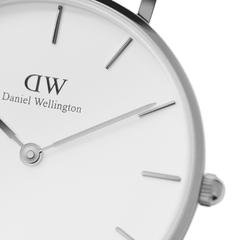 Detail of Petite Sterling women’s watch with eggshell white dial, silver hour markers and slim polished hands by Daniel Wellington.