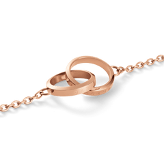 Close-up of Elan Unity Necklace in rose gold with two interlocking rings on a delicate chain, minimalist jewellery.