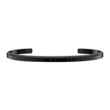 Slim black Daniel Wellington Classic Bracelet cuff in stainless steel with an engraved logo and minimalist design.