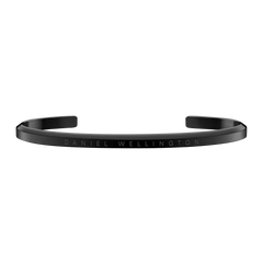 Slim black Daniel Wellington Classic Bracelet cuff in stainless steel with an engraved logo and minimalist design.