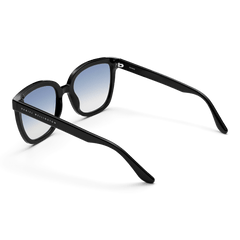Grande Bio-Acetate Black Blue sunglasses with a bold black frame, blue gradient lenses, and Daniel Wellington branding along the arm, shown from a rear angle.
