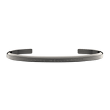 Slim graphite Daniel Wellington Classic Bracelet in polished stainless steel with an engraved logo and minimalist open cuff design.