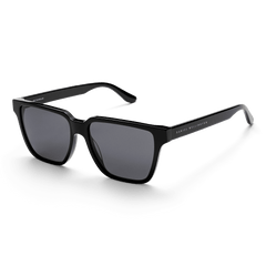 Rectangular Bio-Acetate Black sunglasses featuring deep black frames, matching black lenses, and subtle Daniel Wellington branding on the arms.